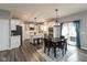 Modern kitchen with white cabinets, stainless steel appliances, an island, and adjacent dining area at 10334 Deercrest Ln, Indianapolis, IN 46239