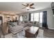 Bright living room with a large sectional sofa and an open view of the kitchen at 10334 Deercrest Ln, Indianapolis, IN 46239