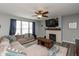 Cozy living room with a fireplace, ceiling fan, and a comfortable sectional sofa at 10334 Deercrest Ln, Indianapolis, IN 46239