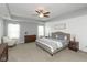 Spacious main bedroom with a tray ceiling, ceiling fan, and natural light at 10334 Deercrest Ln, Indianapolis, IN 46239