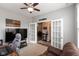 Cozy home office featuring carpet, gray walls, ceiling fan and french doors to another room at 10334 Deercrest Ln, Indianapolis, IN 46239