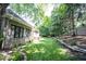 Beautifully landscaped backyard with a lush green lawn, patio seating, and mature trees at 10707 Burning Ridge Ln, Fishers, IN 46037