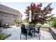 Beautiful backyard patio featuring outdoor seating, a retractable umbrella, and lush landscaping for relaxation and entertainment at 10707 Burning Ridge Ln, Fishers, IN 46037