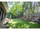 Spacious backyard features a lush green lawn, patio seating, mature trees and a hammock at 10707 Burning Ridge Ln, Fishers, IN 46037
