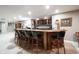 Finished basement bar boasts wooden bar with seating, wine rack, dark countertops, and recessed lighting at 10707 Burning Ridge Ln, Fishers, IN 46037