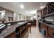Finished basement bar boasts wood cabinets, granite countertops, wine rack, microwave, and mini fridge at 10707 Burning Ridge Ln, Fishers, IN 46037