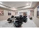Finished basement with reclining chairs arranged around a small table, perfect for entertainment at 10707 Burning Ridge Ln, Fishers, IN 46037