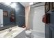 Bathroom featuring blue walls, a shower-tub combination, and a large mirror at 10707 Burning Ridge Ln, Fishers, IN 46037