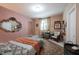 Cozy bedroom with patterned bedding, decorative mirror, eclectic decor, and natural light at 10707 Burning Ridge Ln, Fishers, IN 46037