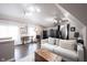 Bright bonus room with hardwood floors, a comfortable sofa, and artist's loft at 10707 Burning Ridge Ln, Fishers, IN 46037