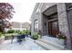 Charming home featuring a front patio with stylish outdoor seating and a well-crafted wooden front door at 10707 Burning Ridge Ln, Fishers, IN 46037