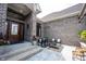 Cozy outdoor patio with seating area, showcasing brick architecture and a welcoming entrance with a wooden door at 10707 Burning Ridge Ln, Fishers, IN 46037