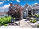 Stunning home with a gorgeous red tree, water fountain, and landscaped front yard at 10707 Burning Ridge Ln, Fishers, IN 46037