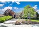 Charming home with a beautifully landscaped front yard with stone accents at 10707 Burning Ridge Ln, Fishers, IN 46037