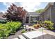 Well-manicured front yard showcasing a beautiful brick home with a pergola-covered entryway and charming accents at 10707 Burning Ridge Ln, Fishers, IN 46037