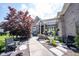 Brick home featuring a beautifully landscaped front yard, complemented by a charming fountain and comfortable seating area at 10707 Burning Ridge Ln, Fishers, IN 46037
