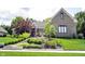 Beautiful brick home featuring meticulously landscaped front yard and well-maintained lawn at 10707 Burning Ridge Ln, Fishers, IN 46037