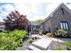 Inviting brick home with a charming front yard, adorned with lush landscaping and a cozy seating area at 10707 Burning Ridge Ln, Fishers, IN 46037