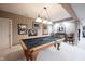 Finished basement game room with pool table, dart board, and classic decor at 10707 Burning Ridge Ln, Fishers, IN 46037