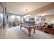 Finished basement game room with pool table, vintage leather couches, bar, and classic decor at 10707 Burning Ridge Ln, Fishers, IN 46037
