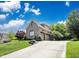 Exterior shot of a home featuring a 3 car garage and long driveway at 10707 Burning Ridge Ln, Fishers, IN 46037