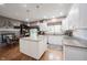 Open kitchen and dining area features white cabinetry, granite countertops, and eat-in dining space at 10707 Burning Ridge Ln, Fishers, IN 46037