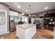 Bright kitchen boasts stainless steel appliances, granite countertops, white cabinets, and center island at 10707 Burning Ridge Ln, Fishers, IN 46037