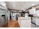 Open concept kitchen with center island, stainless steel appliances, and hardwood flooring at 10707 Burning Ridge Ln, Fishers, IN 46037