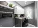 Well-organized laundry room featuring gray walls, white cabinets, and modern washer and dryer at 10707 Burning Ridge Ln, Fishers, IN 46037