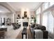 Spacious living room featuring a fireplace, built-ins, and large windows for ample natural light at 10707 Burning Ridge Ln, Fishers, IN 46037