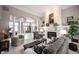 Open living room with fireplace, columns, and view to the front door and dining room at 10707 Burning Ridge Ln, Fishers, IN 46037