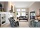 Bright living room with a fireplace, built-in bookshelves, and large windows at 10707 Burning Ridge Ln, Fishers, IN 46037