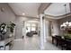 Open living space with tile flooring, decorative columns, and abundant natural light at 10707 Burning Ridge Ln, Fishers, IN 46037