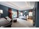 Spacious main bedroom with a sitting area, tray ceiling, and natural light at 10707 Burning Ridge Ln, Fishers, IN 46037