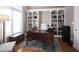 Dedicated home office space with custom built-in shelving and a large desk for productivity at 10707 Burning Ridge Ln, Fishers, IN 46037