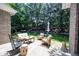 Inviting patio with ample seating, a hammock, and a serene backyard view with mature trees at 10707 Burning Ridge Ln, Fishers, IN 46037