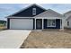 Charming one-story home with navy siding, white trim, a concrete driveway and an attached two-car garage at 1175 Mcbride St, Greenfield, IN 46140