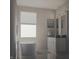 Bright bathroom featuring a modern soaking tub, white vanity with black countertops, and a large window at 11972 Citywalk Dr, Fishers, IN 46038
