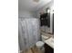 Bathroom featuring tub shower, storage cabinet, and decorative shower curtain at 12389 Titans Dr, Fishers, IN 46037