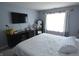 Bright bedroom with light blue walls, dark console, and large window at 12389 Titans Dr, Fishers, IN 46037