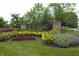 The Bristols community entrance with colorful flowerbeds and lush greenery at 12389 Titans Dr, Fishers, IN 46037