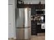 Kitchen with stainless steel refrigerator, dark cabinets, and modern appliances at 12389 Titans Dr, Fishers, IN 46037