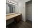 A bathroom vanity with a sink, large mirror, decorative lighting, and closet with storage at 12639 Justice Xing, Fishers, IN 46037