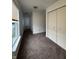 A bright bedroom features neutral walls, carpeting, and a double door closet for ample storage at 12639 Justice Xing, Fishers, IN 46037