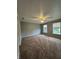 A spacious bedroom features neutral walls, carpeting, ceiling fan, and large windows for lots of natural light at 12639 Justice Xing, Fishers, IN 46037