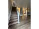 Inviting foyer featuring staircase and modern flooring that flows into the living area at 12639 Justice Xing, Fishers, IN 46037
