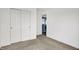 Carpeted bedroom with closet, a partially opened doorway, and neutral walls at 1571 N Creekwater Pass, Greenfield, IN 46140
