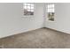 Bright bedroom with neutral carpet, two windows providing natural light, and white walls at 1571 N Creekwater Pass, Greenfield, IN 46140