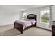 A primary bedroom featuring neutral decor, a large bed, and natural light from a window at 1571 N Creekwater Pass, Greenfield, IN 46140