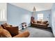 Comfortable bonus room with cozy seating, neutral walls, and natural light from large windows for relaxing and entertaining at 1571 N Creekwater Pass, Greenfield, IN 46140